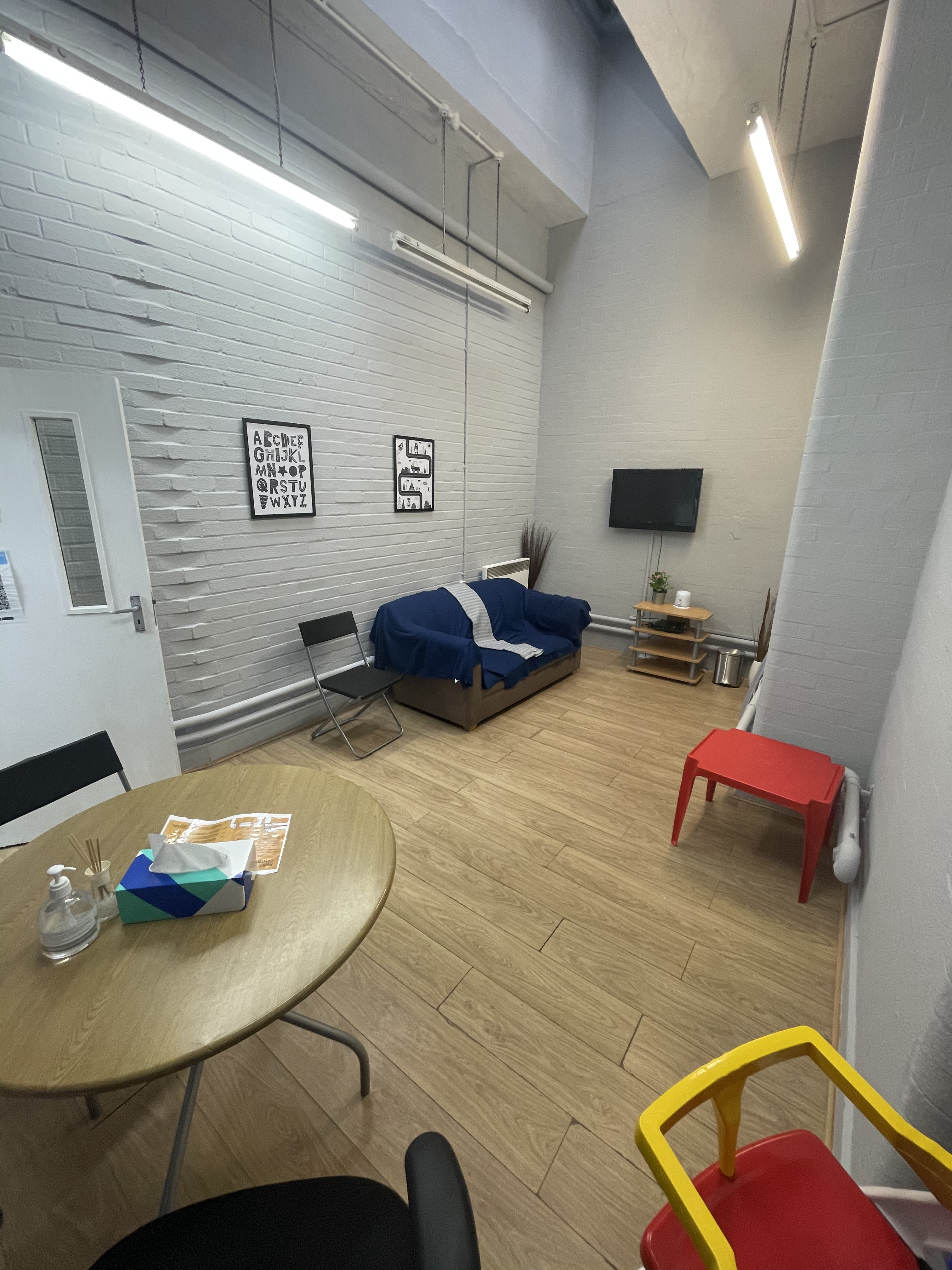 room with tv, table and sofa 