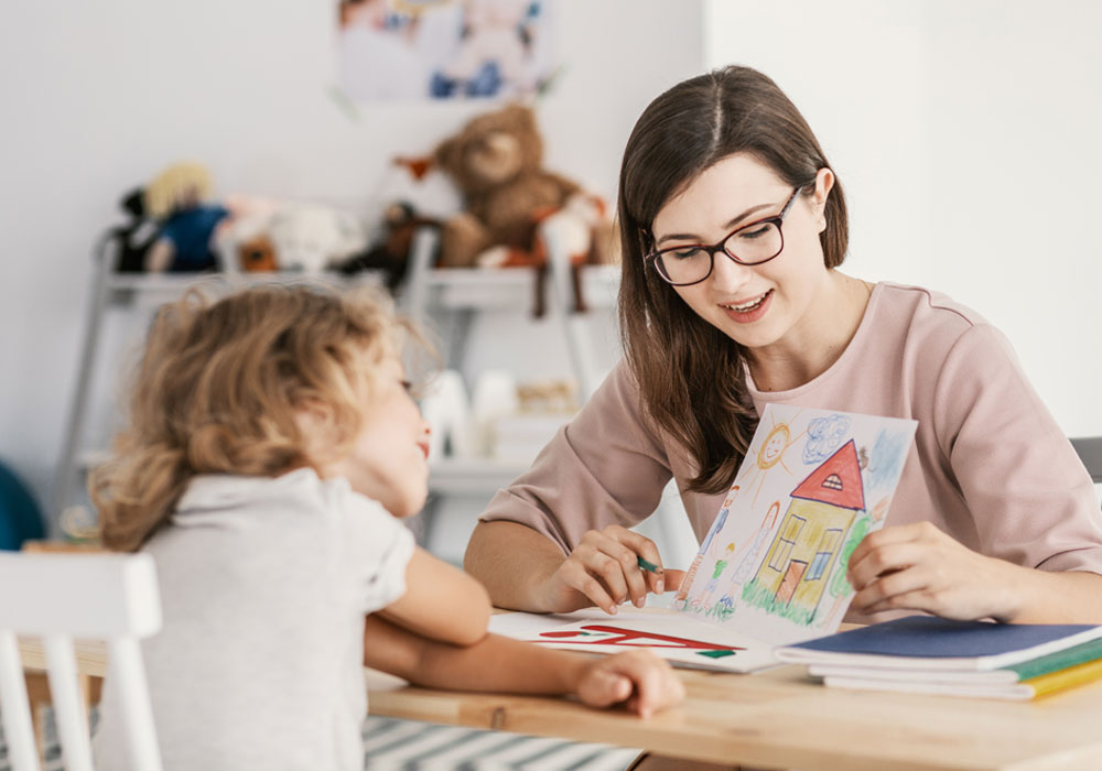 Adult helping child draw a nice picture 